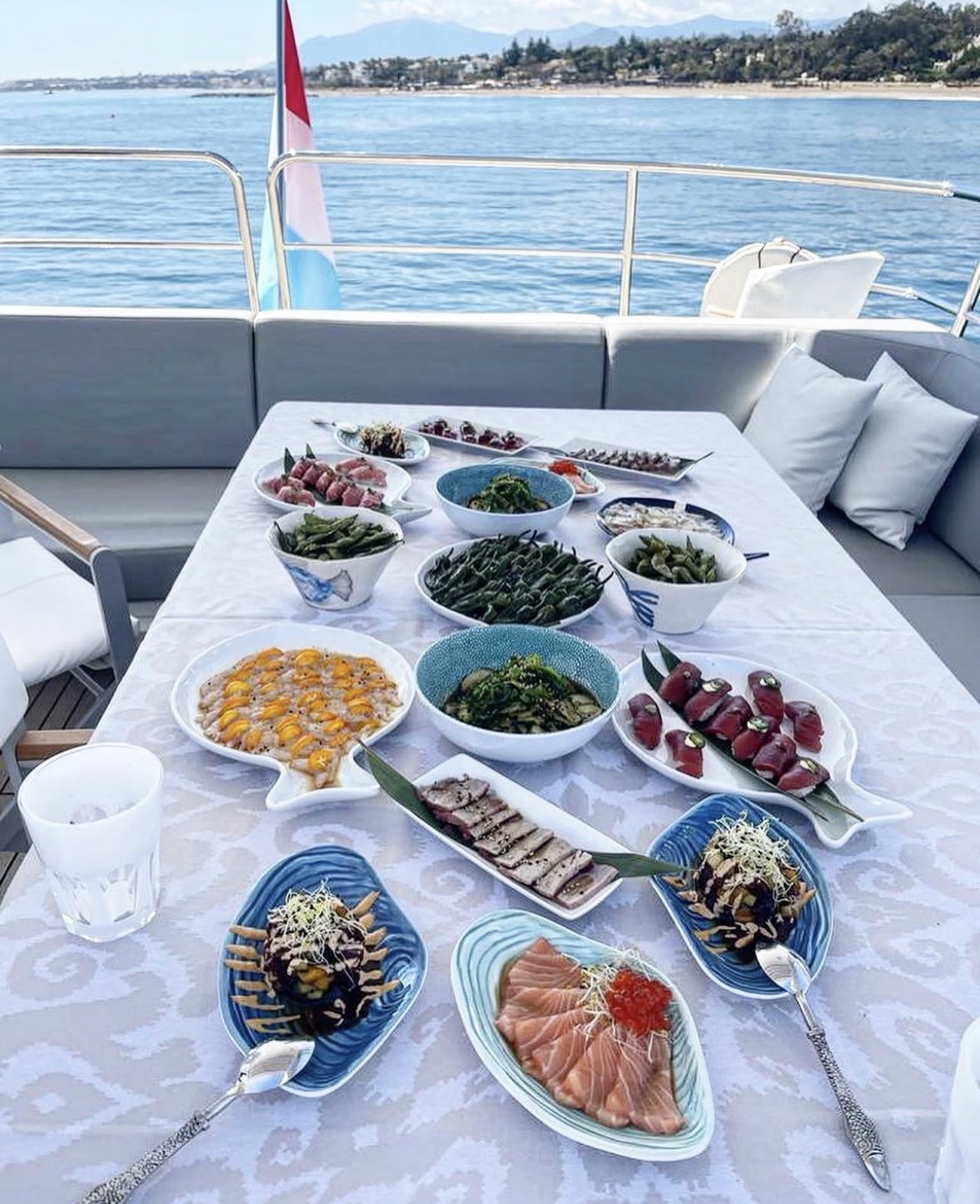 Sélection de sashimis et de plats japonais servie sur un yacht